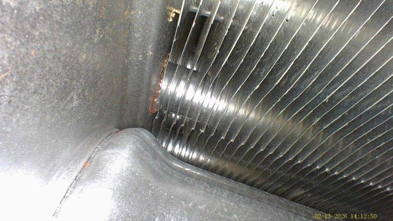 Responded to service call for a 16-year-old furnace that was shutting off prematurely after short periods of normal operation. Inspection revealed significant frost buildup on the refrigerant lines and evaporator coils, indicating restricted airflow. Cleaned cooling fins and removed corrosion from connection points to restore proper system function.
