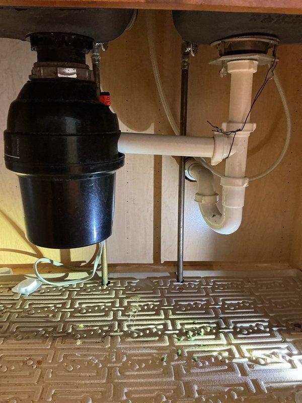 Replaced leaking toilet supply valve at primary location with new quarter-turn valve to eliminate stem leak. Installed additional supply valves on two secondary toilets as preventative measure. Removed old garbage disposal and installed customer-provided replacement unit, confirming proper operation and absence of leaks.