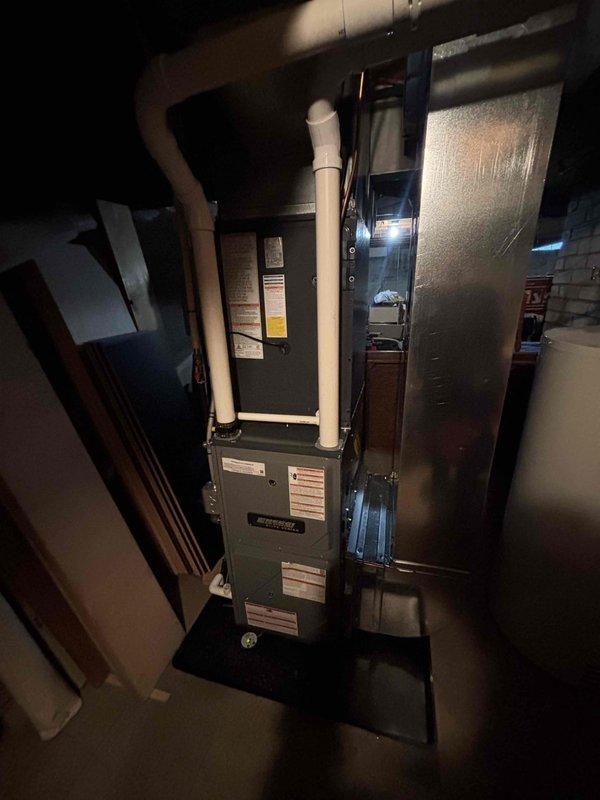 Successfully completed installation of new Goodman furnace and AC system, including proper mounting of the outdoor condenser unit on concrete pad with refrigerant line connections and installation of the indoor furnace with PVC venting in the utility area. System was fully tested and is operating according to manufacturer specifications.