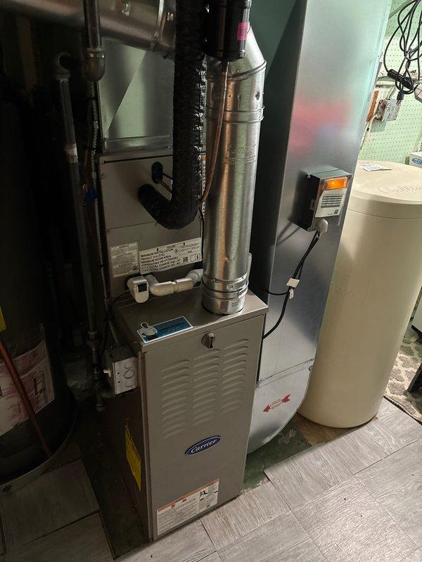 Successfully completed installation of new Carrier furnace and AC system. Installed outdoor condenser unit on ground level with proper line connections to the home. Set up indoor furnace unit with appropriate metal venting components and connected all necessary electrical and control systems.