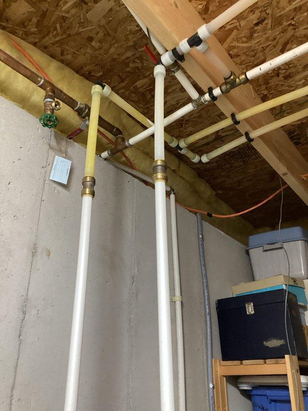 Performed estimate for replacement of non-functioning 18-year-old electric water heater with a heat pump water heater. Inspected existing installation in unfinished basement with exposed plumbing infrastructure, documented current water heater condition, and evaluated space requirements for new unit installation.