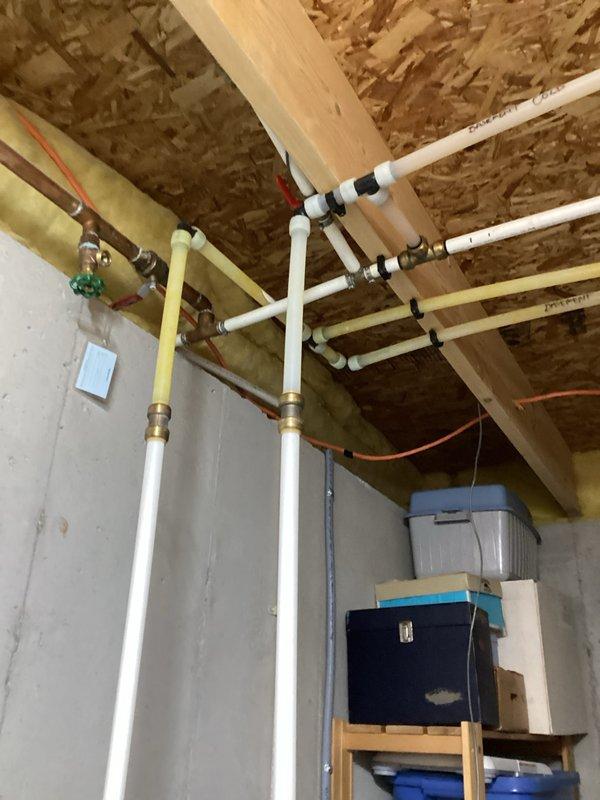 Performed estimate for replacement of non-functioning 18-year-old electric water heater with a heat pump water heater. Inspected existing installation in unfinished basement with exposed plumbing infrastructure, documented current water heater condition, and evaluated space requirements for new unit installation.
