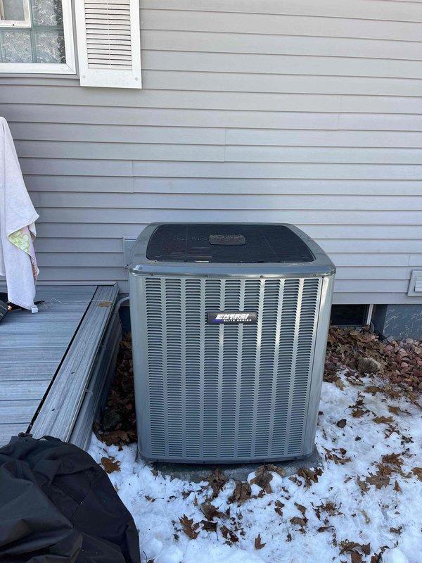 Successfully installed new furnace system with AprilAire humidifier and digital control panel in utility area, complete with proper ductwork connections and manufacturer documentation. Exterior Amana air conditioning unit was positioned on concrete pad with all necessary connections made to complete full HVAC system replacement.