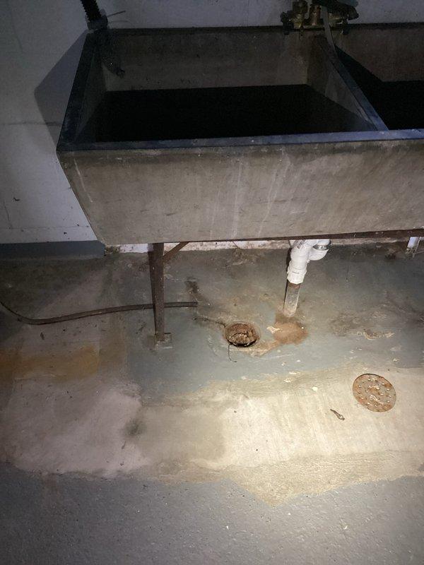 Responded to emergency call for sewage backup caused by failed lift pump. Completed inspection of basement drainage system, including concrete utility sink and floor drains showing previous water damage. Capped exposed pipe in basement as requested and verified proper operation of sump pump system near laundry area to prevent future backups.