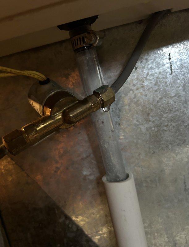 Diagnosed and repaired water leak from humidifier connected to 12-year-old EcoAir furnace system. Identified failed water supply connection with visible bubbling in clear tube and water droplets on brass valve assembly. Replaced damaged components and verified proper operation of humidifier with no further leakage.