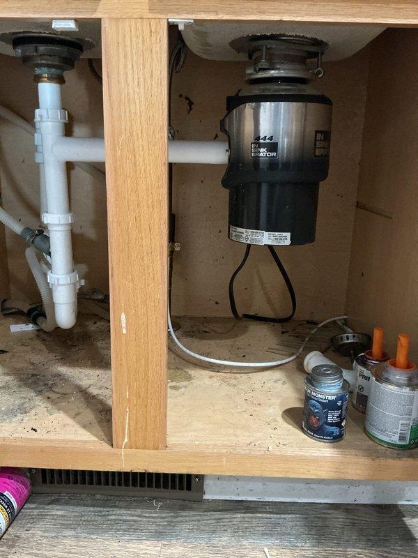Responded to service call for improperly installed garbage disposal. Discovered previous installer had used piping that was too short between disposal and sink, causing leaks. Properly reconnected the disposal with correctly sized PVC piping and verified system for leak-free operation.