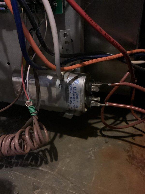 Performed annual heating maintenance on 11-year-old Goodman furnace. Inspected electrical components including capacitor and wiring connections. Noted minor surface rust on metal housing but system operating normally. No humidifier present. Completed tune-up according to manufacturer specifications.