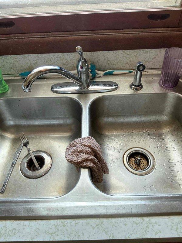 Responded to a plumbing leak call regarding a Neptune valve installation. Inspected the valve assembly mounted against wooden wall paneling with insulation material and identified the source of leakage affecting the kitchen sink area. Replaced faulty valve components and performed pressure testing to confirm proper function and verify leak resolution.