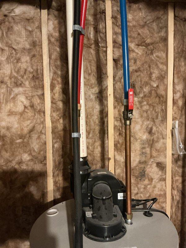 Diagnosed 6-year-old water heater with active leak at tank body, indicating tank failure. Recommended complete replacement as repair is not feasible for this type of internal corrosion issue. Documented condition with photos showing installation location in utility space with exposed insulation and surrounding plumbing connections.