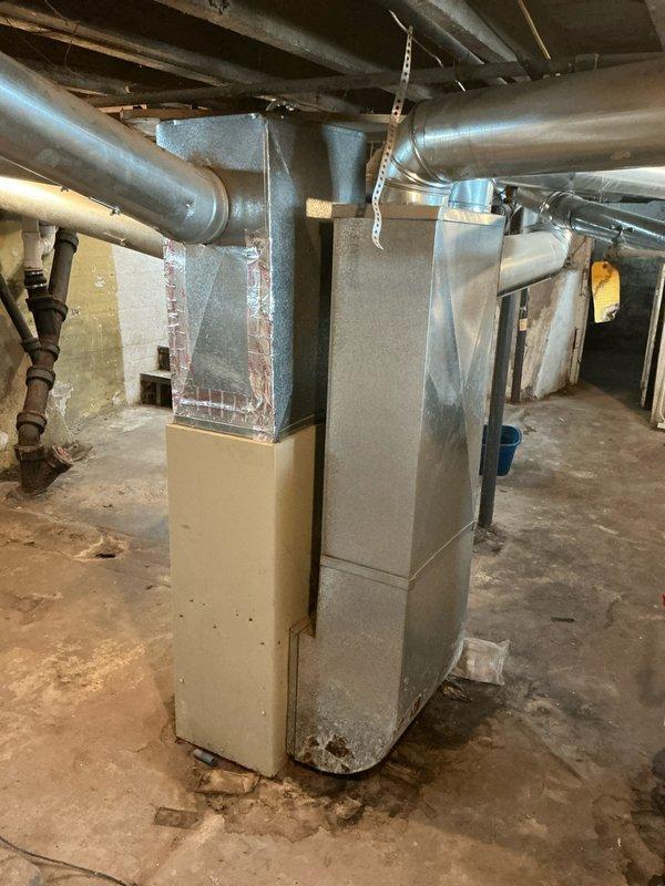 Diagnosed 25+ year old furnace with limit switch failure as indicated by blinking HTX status light. Inspected aging system components including heat exchanger, ductwork connections, and drainage system in basement installation. Recommended replacement due to unit's advanced age, visible wear, and repair cost considerations versus efficiency benefits of modern equipment.