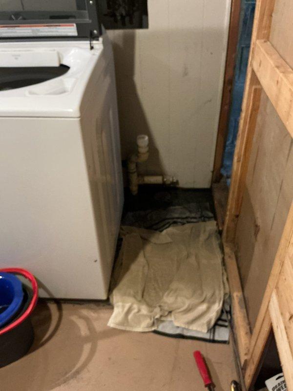 Responded to basement drain backup issue occurring when upstairs toilet is flushed. Inspected the utility area with exposed plumbing and identified water damage and staining around floor drain. Cleared blockage in main drain line causing sewage to back up through basement floor drain during toilet usage.