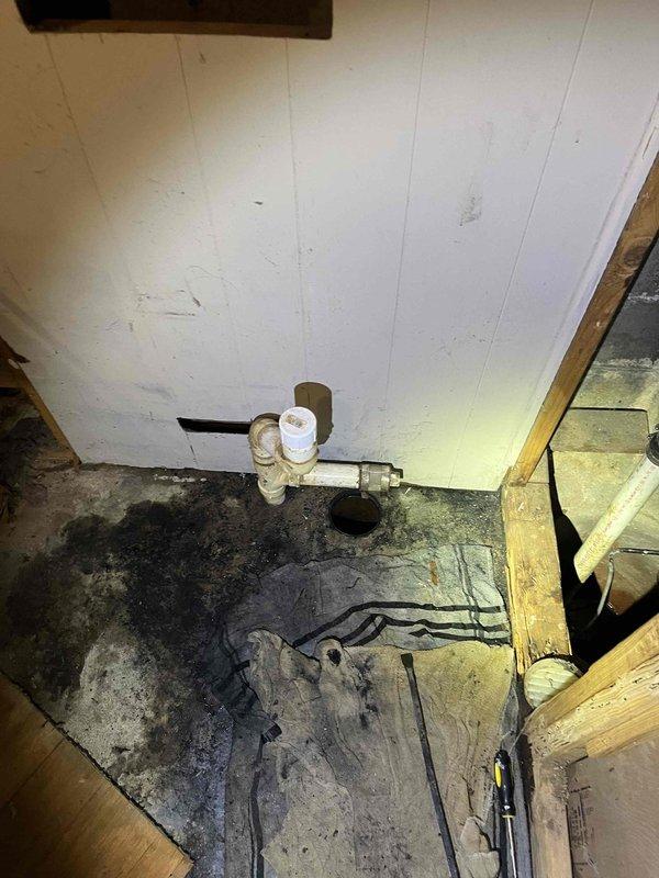 Responded to basement drain backup issue occurring when upstairs toilet is flushed. Inspected the utility area with exposed plumbing and identified water damage and staining around floor drain. Cleared blockage in main drain line causing sewage to back up through basement floor drain during toilet usage.