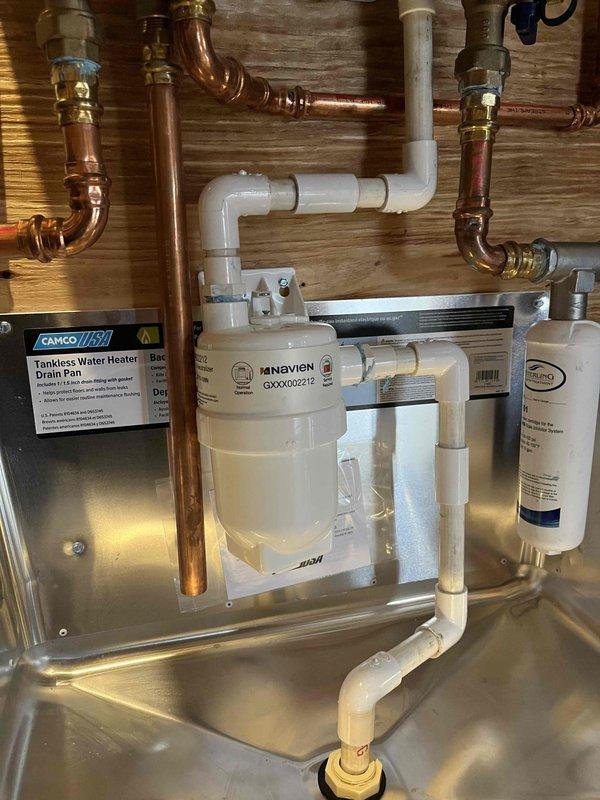 Successfully completed the replacement of condensation resin beads in the Navien tankless water heater system. Serviced the filtration assembly connected to copper supply lines and PVC drainage components, ensuring proper installation and functionality. System is now operating at optimal efficiency with the new resin media in place.