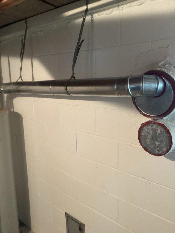 Completed annual heating system maintenance and humidifier tune-up on 7-year Energy Wise equipment (warranty through 9-2028). Inspected ventilation ducting and water heater, noting proper installation of exhaust piping and confirming all connections are secure. Documentation completed with photographic evidence of system components.