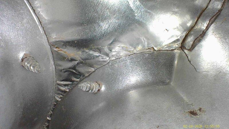 Responded to water leak issue with whole-house Aprilaire humidifier connected to furnace. Inspection revealed damaged metal ductwork with multiple tears and rips causing significant water leakage. Identified small hole in metal surface that contributed to the problem.