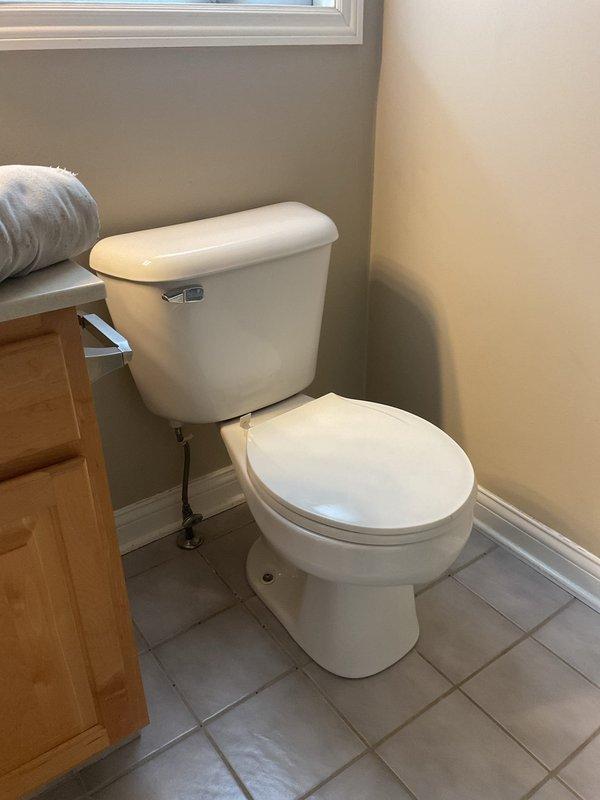 Successfully completed comfort height elongated toilet replacement in bathroom. Removed existing standard toilet and installed new comfort height model with proper water supply connection. Verified proper functioning and no leaks upon completion.