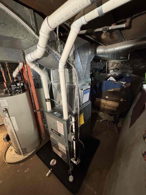 Successfully completed installation of new residential furnace unit with PVC ventilation system. Connected all required ductwork, including proper venting configuration, and positioned unit on protective drip pan in basement mechanical room. System was fully tested and verified operational alongside existing water heater.