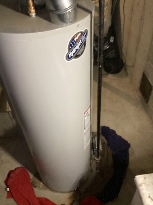 Performed diagnostic inspection on water heater of indeterminate age in basement utility room. Unit was operational and still producing hot water. Verified proper ventilation through existing ductwork and confirmed all connections were secure. No active leaks or safety concerns identified at time of service.