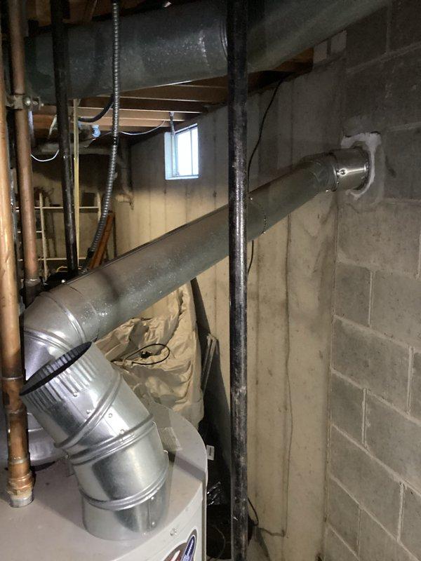 Performed diagnostic inspection on water heater of indeterminate age in basement utility room. Unit was operational and still producing hot water. Verified proper ventilation through existing ductwork and confirmed all connections were secure. No active leaks or safety concerns identified at time of service.