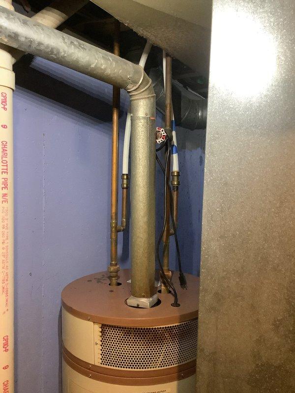 Inspected 30-year-old water heater with active leak and no hot water output. Documented water damage on surrounding wall surfaces. Provided customer with replacement options and coordinated with their home warranty provider for potential coverage.