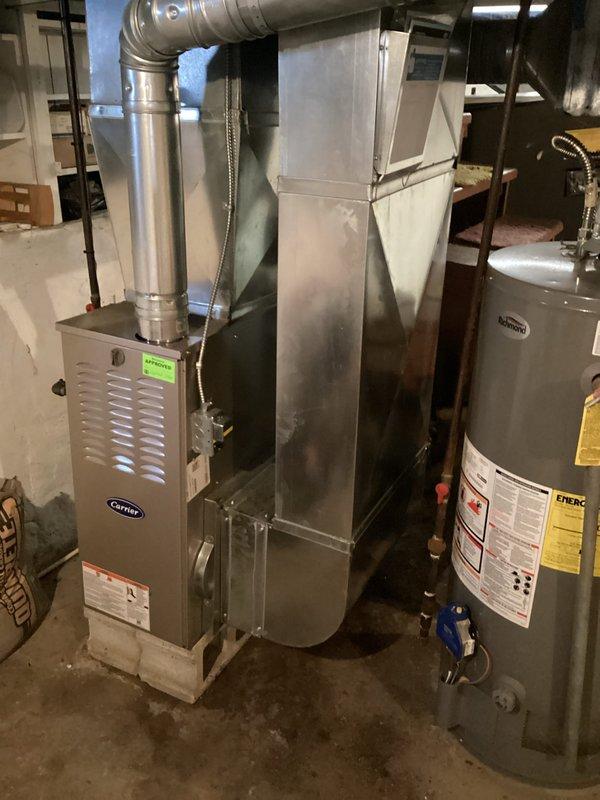 Completed annual heating maintenance on a 4-year-old Carrier furnace (model WT 02-2031). Performed comprehensive inspection with front panel removed to examine blower motor, electrical components, and exhaust flue. System is functioning properly with no operational issues identified. Photographic documentation of equipment and internal components was taken for service records.