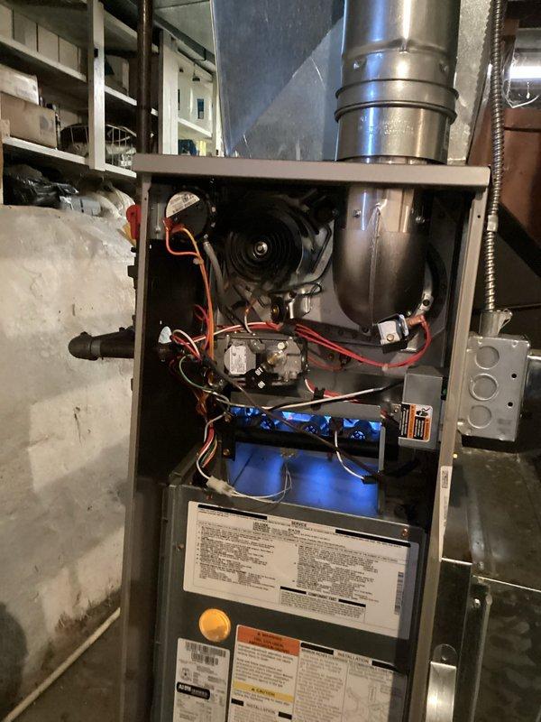 Completed annual heating maintenance on a 4-year-old Carrier furnace (model WT 02-2031). Performed comprehensive inspection with front panel removed to examine blower motor, electrical components, and exhaust flue. System is functioning properly with no operational issues identified. Photographic documentation of equipment and internal components was taken for service records.