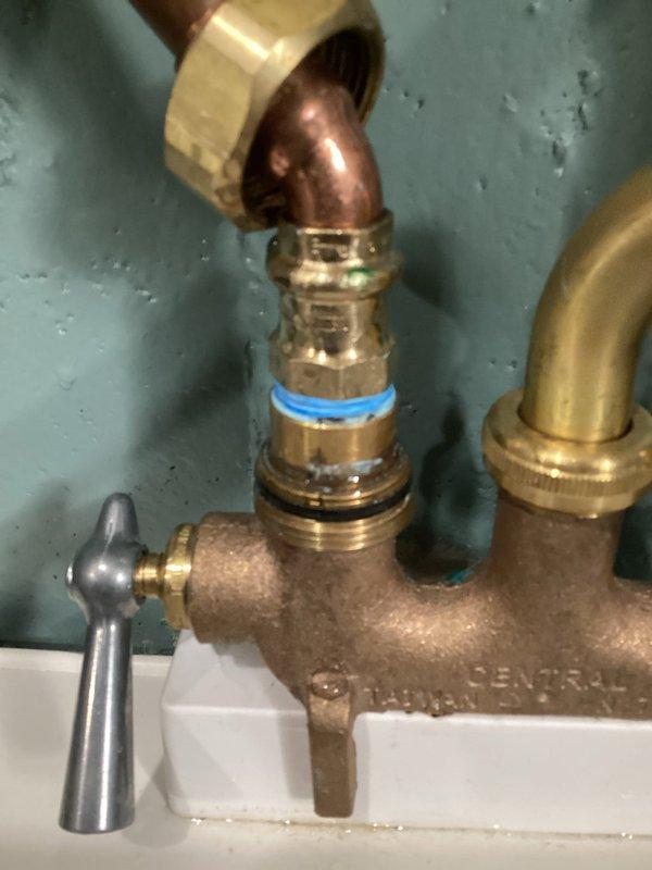 Repaired plumbing leak at a brass Central mixing valve in 47-year-old residence. Identified compromised compression fitting with blue indicator ring at copper pipe connection. Replaced fitting and tested system to confirm complete resolution of leak that had been occurring for approximately ten days.