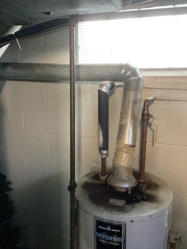 Responded to service call for a 12-year-old Defender water heater not producing hot water. Diagnosed faulty thermocouple causing pilot light failure. Replaced thermocouple, cleaned burner assembly, and verified proper ignition and heating function. Water heater now operating normally with good hot water production.