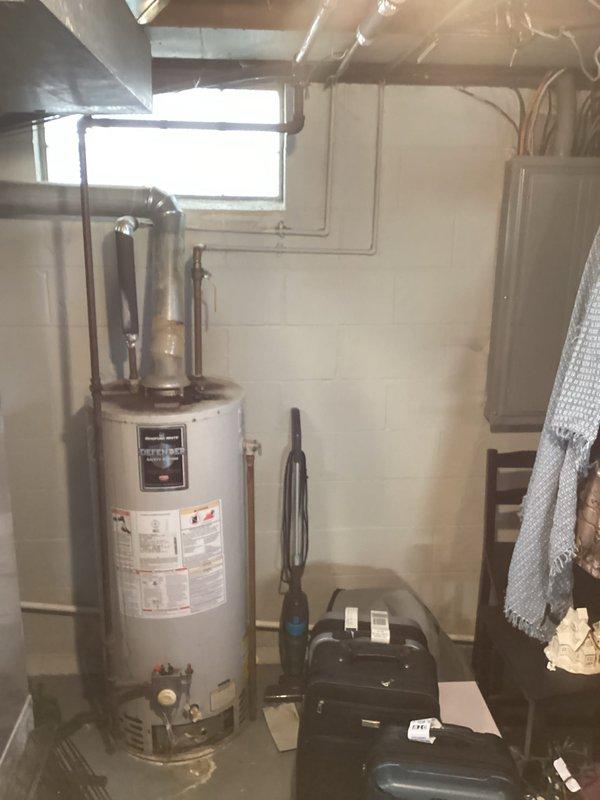 Responded to service call for a 12-year-old Defender water heater not producing hot water. Diagnosed faulty thermocouple causing pilot light failure. Replaced thermocouple, cleaned burner assembly, and verified proper ignition and heating function. Water heater now operating normally with good hot water production.