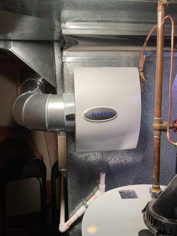 Successfully installed an AprilAire humidifier unit, connecting it to the existing HVAC ductwork system with proper metallic connections. Completed water supply line installation using copper piping with brass fittings and established PVC drainage system for condensate removal.
