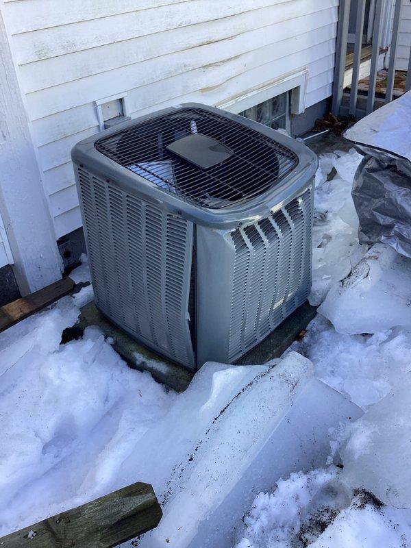 Conducted inspection of outdoor air conditioning unit after customer reported ice damage to condenser. Evaluation revealed denting on condenser coil casing from fallen ice sheet. Unit is functioning properly despite cosmetic damage; no refrigerant leaks detected and all components operating within normal parameters. Recommended continued monitoring during next cooling season.