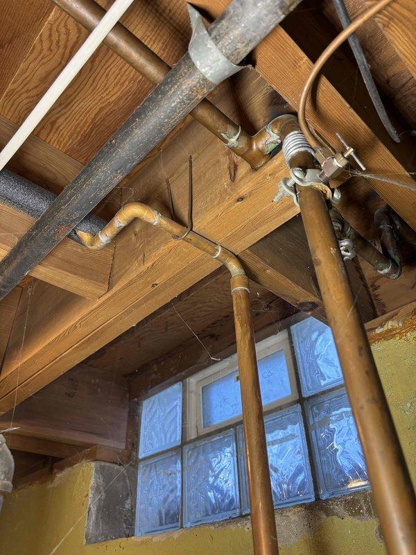 Performed water heater replacement estimate for a 25-year-old unit currently leaking from the bottom. Inspection revealed aging tank with deteriorated insulation and corrosion at base. Documented existing venting system and plumbing connections in unfinished basement to ensure proper specifications for replacement unit.