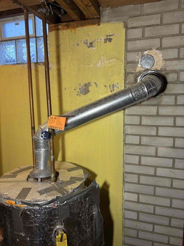 Performed water heater replacement estimate for a 25-year-old unit currently leaking from the bottom. Inspection revealed aging tank with deteriorated insulation and corrosion at base. Documented existing venting system and plumbing connections in unfinished basement to ensure proper specifications for replacement unit.