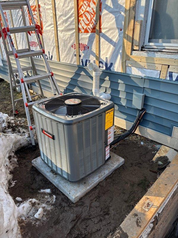 Successfully installed new Lennox Elite Series HVAC system including outdoor condensing unit on concrete pad with proper connections to the home. Complete installation included indoor furnace unit with PVC venting and ADEX-CLASSIC component, all properly connected to electrical panel and ductwork in utility area.