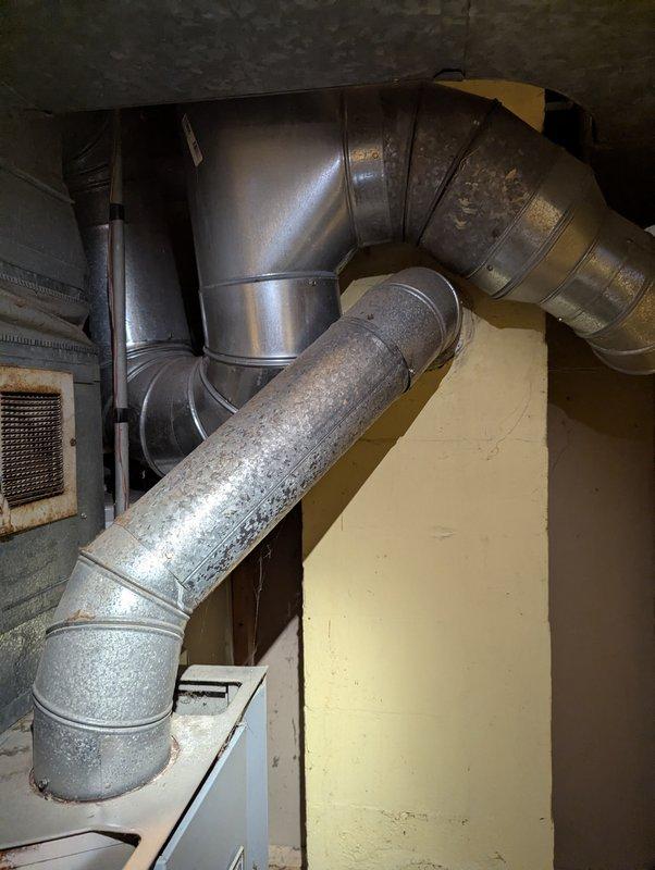 Replaced leaking 5-year-old water heater that showed significant corrosion and water damage. Observed rust stains running down tank sides and substantial water damage to the concrete floor beneath the unit. Installed new water heater and verified proper connection to existing ductwork system.