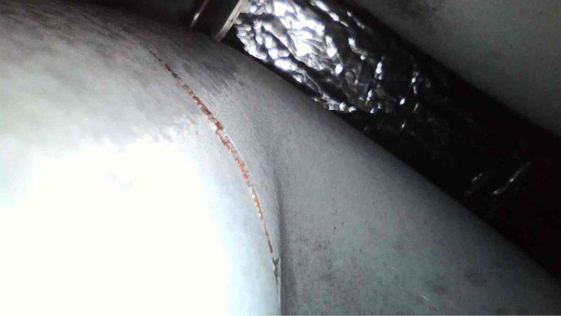 Performed annual preventative maintenance on a 5-year-old Carrier furnace. Observed and documented structural damage including a horizontal crack in adjacent wall and possible early corrosion on HVAC ductwork. System is functioning adequately but recommended monitoring the condition of the insulation and addressing the wall damage to prevent future issues.