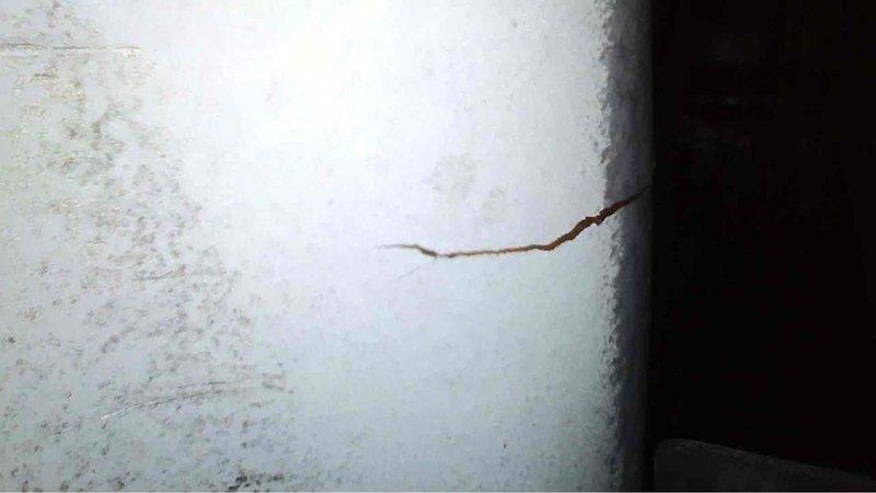 Performed annual preventative maintenance on a 5-year-old Carrier furnace. Observed and documented structural damage including a horizontal crack in adjacent wall and possible early corrosion on HVAC ductwork. System is functioning adequately but recommended monitoring the condition of the insulation and addressing the wall damage to prevent future issues.