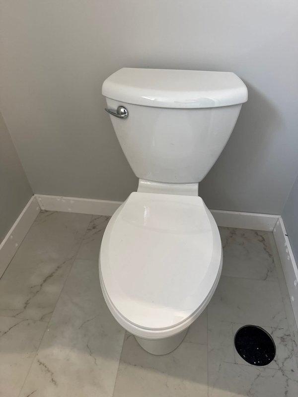 Completed the Mason finishing plumbing project by installing a white porcelain toilet with chrome flush handle and a modern bathroom vanity with rectangular white sink basin featuring black faucet and drain fixtures. All fixtures were properly connected to existing plumbing, tested for leaks, and confirmed to be in good working order with proper drainage.
