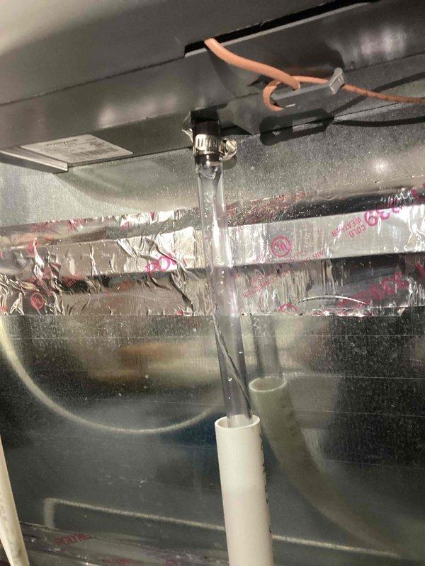 Responded to water leak report at 8-year-old TRA furnace system showing moisture under unit. Inspection revealed condensation forming on refrigerant line insulation and drain assembly. System remains fully operational with no impact to heating and cooling functions.