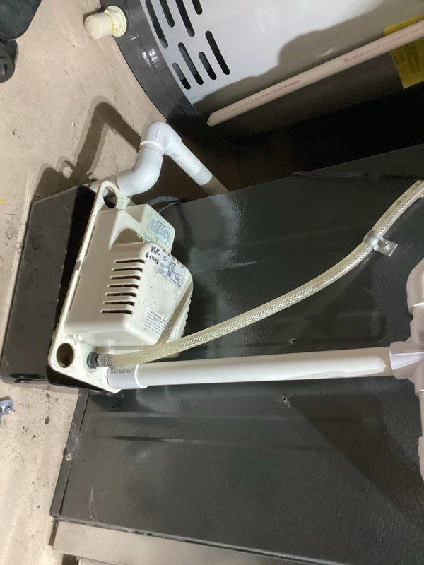 Completed annual heating service on a 5-year-old EnergiAir furnace (model WT 03-2030, manufactured 2018) with attached humidifier. Inspected and photographed the condensate pump system, which appears to be functioning properly with clear drain lines and proper PVC connections. No issues identified during the tune-up service.