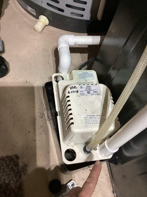 Completed annual heating service on a 5-year-old EnergiAir furnace (model WT 03-2030, manufactured 2018) with attached humidifier. Inspected and photographed the condensate pump system, which appears to be functioning properly with clear drain lines and proper PVC connections. No issues identified during the tune-up service.