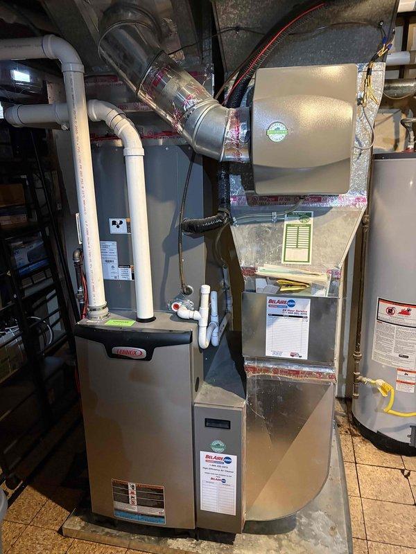 Diagnosed and repaired water heater leak originating from pressure relief valve discharge tube. Replaced corroded brass fitting and discharge pipe to restore proper drainage functionality and prevent further leaking.