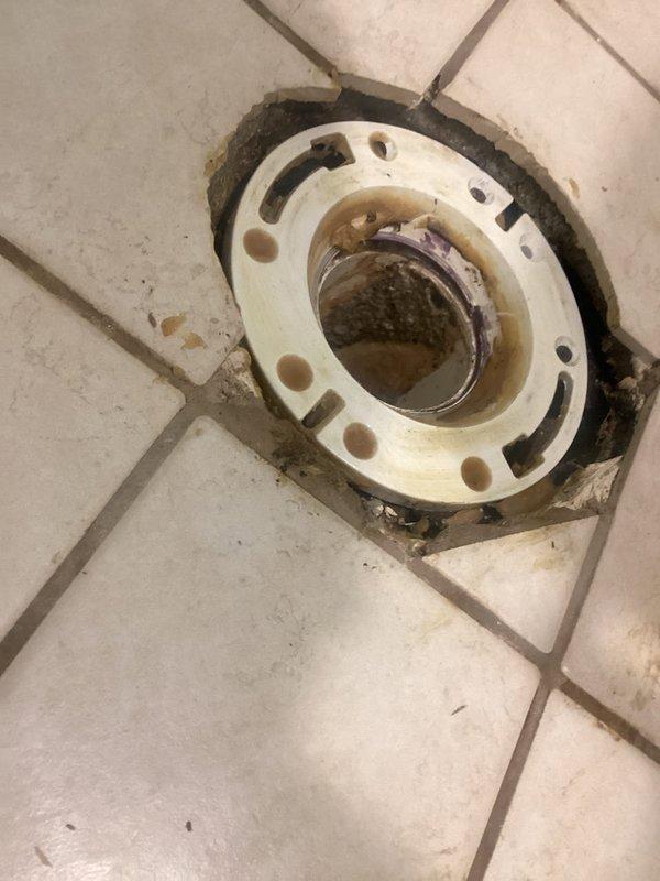 Responded to a service call for a leaking basement toilet in an older home (1949 construction). Upon inspection, found damaged toilet flange with visible discoloration and staining. Removed existing toilet, replaced deteriorated flange, and installed new wax ring and seals to prevent further water seepage. Verified proper function of waste pipe connections and ensured no leakage after reinstallation.