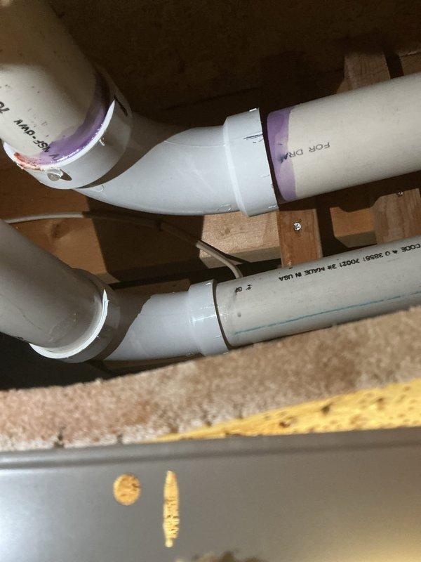 Performed annual heating service on 12-year-old Gibson furnace. Identified and documented small leak from condensate line. Took diagnostic photos of the PVC drain pipe configuration and access point showing the leak area. Customer is on maintenance club; no humidifier present on system. Customer prefers paper receipts.