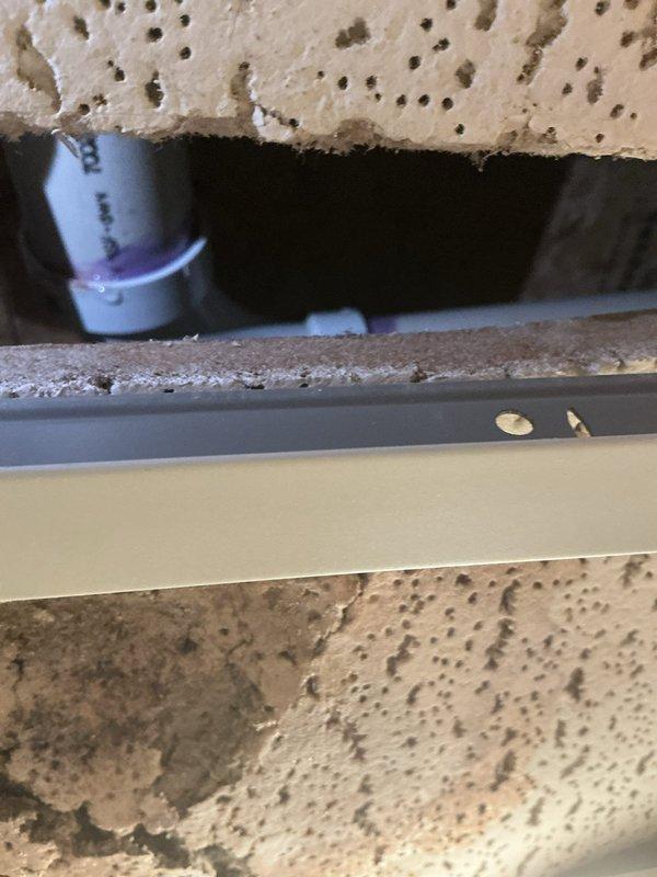 Performed annual heating service on 12-year-old Gibson furnace. Identified and documented small leak from condensate line. Took diagnostic photos of the PVC drain pipe configuration and access point showing the leak area. Customer is on maintenance club; no humidifier present on system. Customer prefers paper receipts.