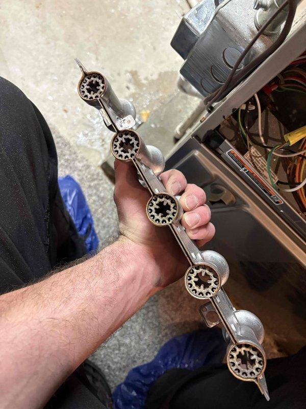 Performed annual maintenance on 11-year-old Carrier furnace. Removed and inspected burner assembly, which showed normal wear but remains in good working condition. System includes a humidifier that was checked during service. All components cleaned and reinstalled with proper operation verified.