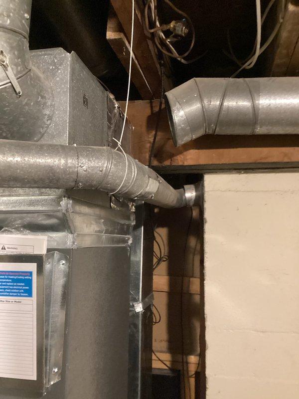 Completed water heater replacement estimate for aging unit (2024 model). Documented existing installation configuration including copper water lines with proper hot/cold connections and surrounding HVAC ductwork. Photographed current mechanical system setup for reference in preparation of replacement proposal.