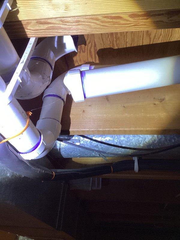 Performed annual heating maintenance on 15-year-old Bryant furnace per Comfort Club membership. Inspected plumbing and ventilation components in basement area including PVC drainage system and HVAC ductwork; all components in good working condition with no visible damage or deterioration. Examined utility room plumbing installation with galvanized steel pipe connected to brass valve fitting and PVC assembly - no leaks or corrosion detected.