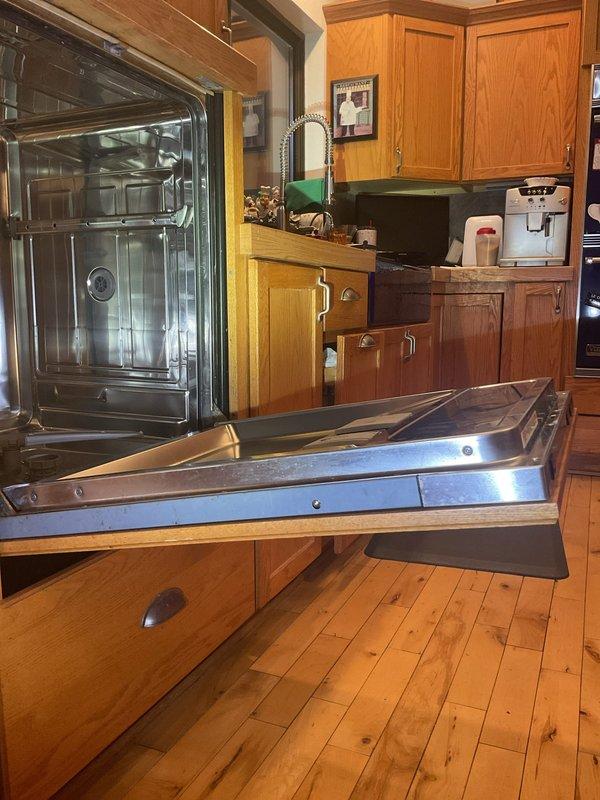 Successfully completed dishwasher installation in kitchen with oak cabinetry. Verified proper operation and documented installation with photos showing the unit integrated with existing stainless steel appliances. Installation completed as requested with Friends & Family discount applied.