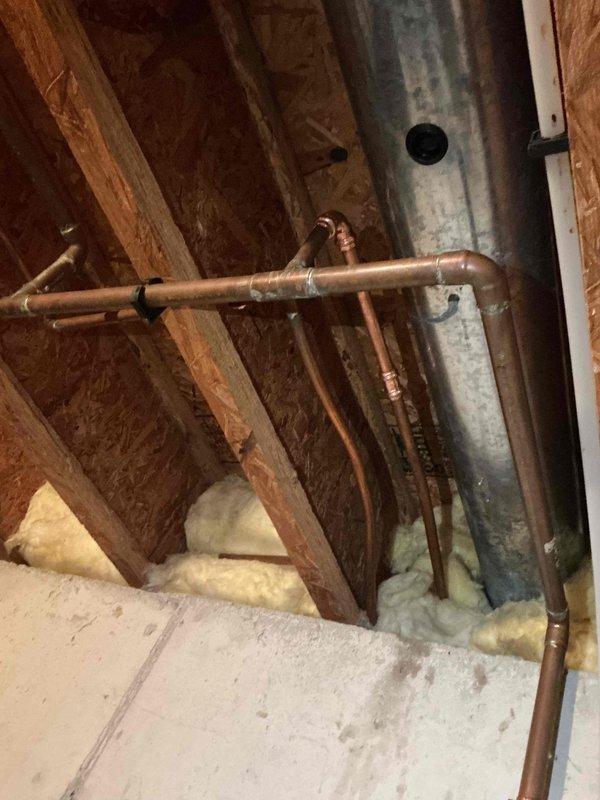 Responded to emergency plumbing leak in basement requiring water shutoff to property. Upon inspection, discovered copper pipe leak in crawlspace/attic area where pipes run alongside HVAC ductwork and structural framing. Successfully isolated and repaired the compromised section of copper piping, restored water service, and verified system integrity with pressure testing.